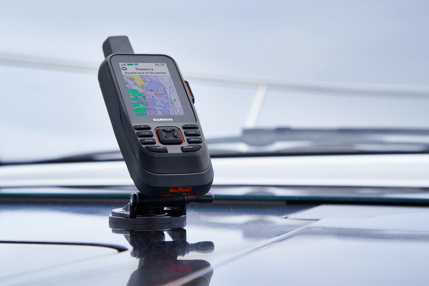Garmin GPSMAP 86Sci marine handheld GPS navigator, refurbished, black with orange accents, mounted on a car roof.
