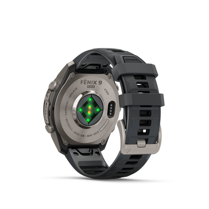 Garmin Fenix 9 Pro smartwatch with titanium case and graphite-black silicone band, rear view with green sensor LEDs.