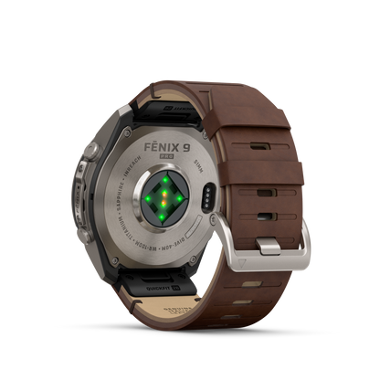 Garmin Fenix 9 Pro smartwatch with walnut leather strap and gray-silver silicone band, titanium case back.