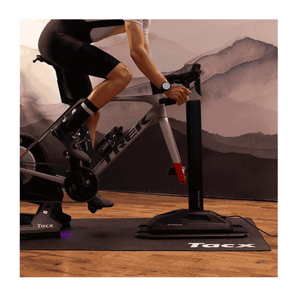 Garmin Tacx Alpine indoor bike trainer with a Trek road bike mounted on a Tacx mat.